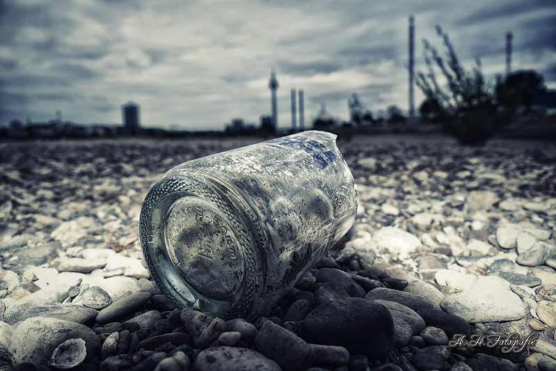 Vodka on the rocks Broken bottle on the banks of the river Rhine during very low water levels