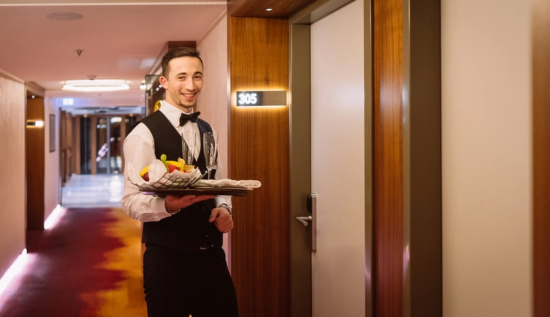 Crew Member delivers room service to an AmaMagna suite